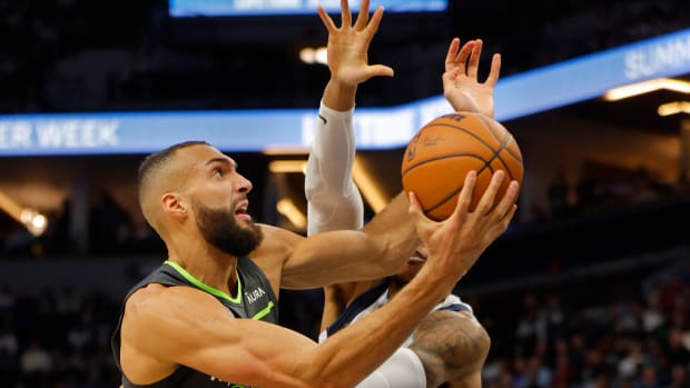 Jan 31, 2024; Minneapolis, Minnesota, USA; Minnesota Timberwolves center Rudy Gobert (27) works around Dallas Mavericks center Richaun Holmes (20) in the fourth quarter at Target Center.